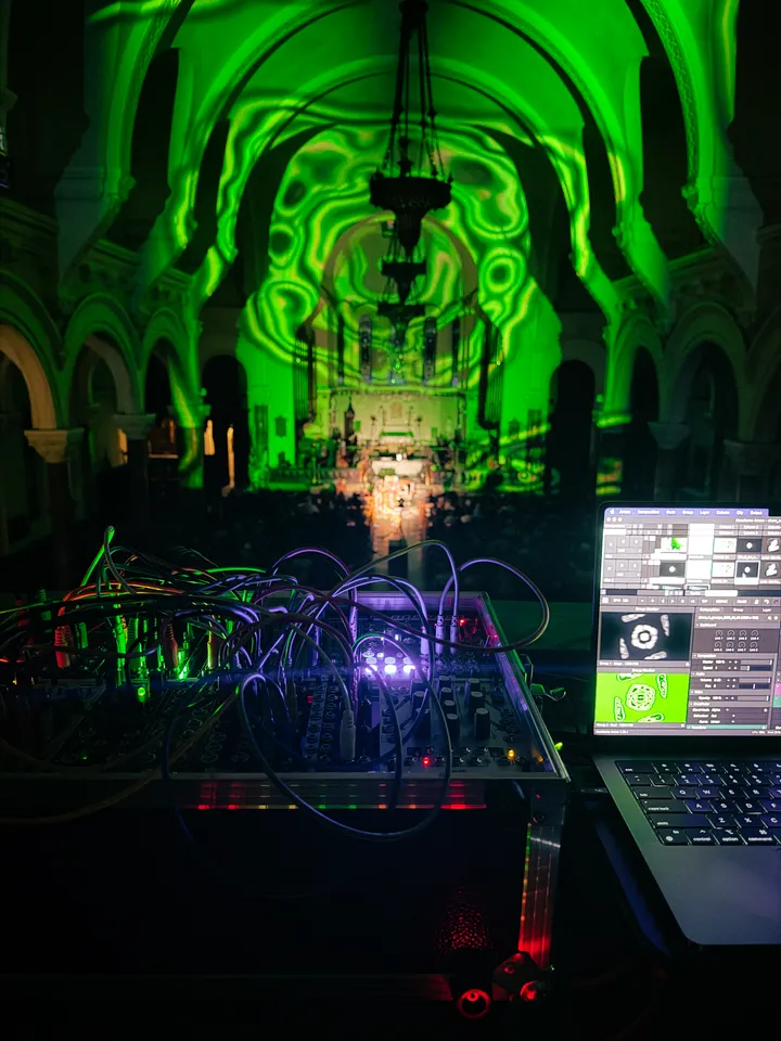 A dark church with colorful visuals by Paloma Kop projected onto the architecture