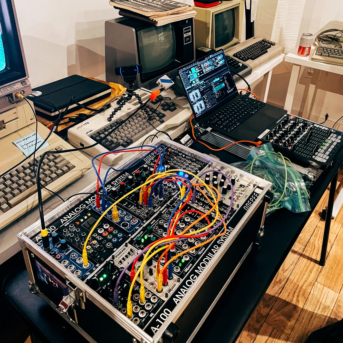 Full video setup comprised of a modular video synth and a laptop with a midi controller