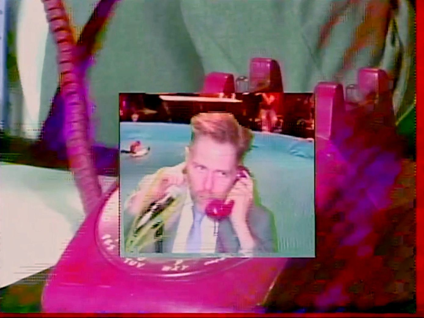 Screenshot from Recursive News performance featuring Allen Riley talking on the phone