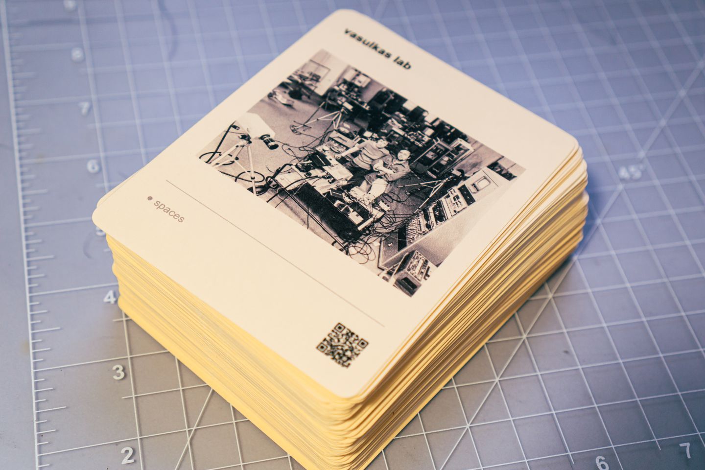 A stack of cards on a blue cutting mat