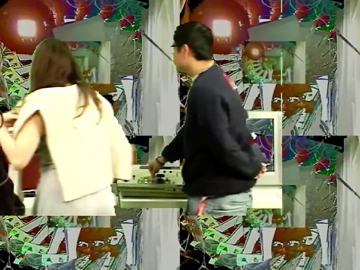 Students manipulating analog video equipment, keyed over feedback chaos