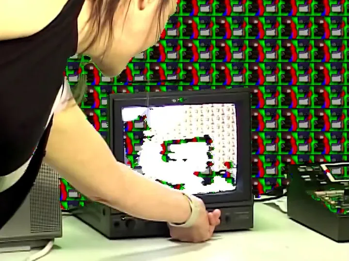 Anna adjusting the television set