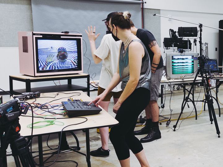 People interacting with video equipment